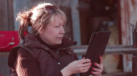 Woman looking into the tablet computer Stock Footage 37764080