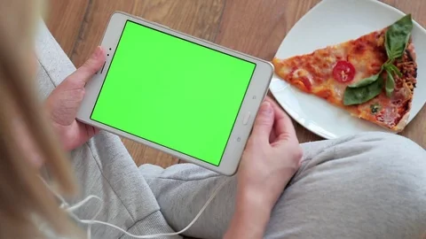 Woman looking at tablet computer with green screen in home Stock Footage 86463089