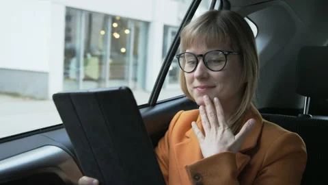 Woman Looking at the Tablet With one Hand on her Chin Stock Footage 87457773