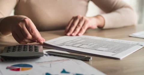 Woman looking at tax forms Stock Footage 60954548