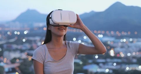 Woman looking though VR device Stock Footage 78126766