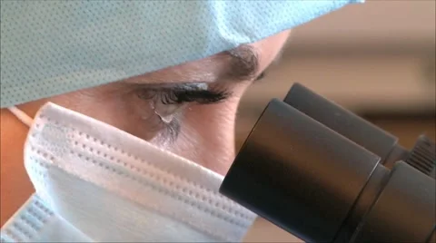 Woman looking through a microscope, close-up Stock-Footage 10715780