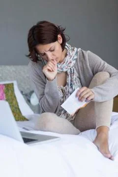 Woman looking upset while using a laptop Stock Photos