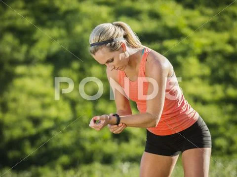 Woman looking at watch Stock Photos