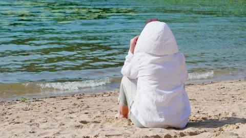 A woman is looking at the waves Stock Footage 317145867