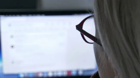 Woman looking for wok at LinkedIn as Java Script developer on laptop at home Stock Footage 166119815