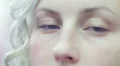 woman looks around with her blue eyes - macro HD Footage