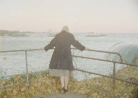 A woman looks down at niagara falls Stock Footage 339631553