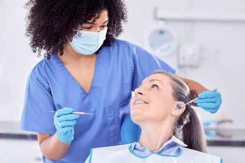 A woman loses her illusions first, her teeth second. a woman and her dentist in Stock Photos