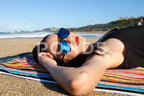 Woman Lying On Beach Towel