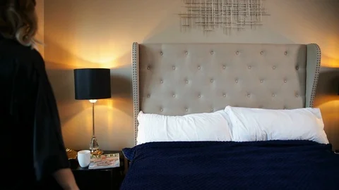 Woman lying in bed while reading a magazine. Video stock 106845245