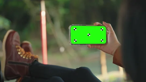 Woman lying at camping tent using smartphone with green screen concept Stock-Footage 220934830
