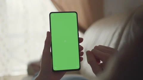 Woman Lying on Couch Using Smartphone With Chroma Key Green Screen Scrollin.. Video stock 327394572