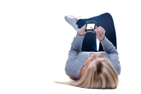 Woman lying down writing on her pda isolated Stock Photos