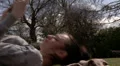 Woman lying on grass reading HD Footage