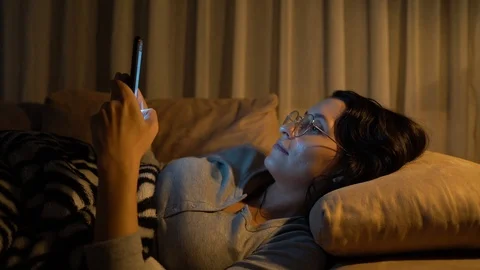 Woman lying on sofa using smart phone Stock Footage 121568314