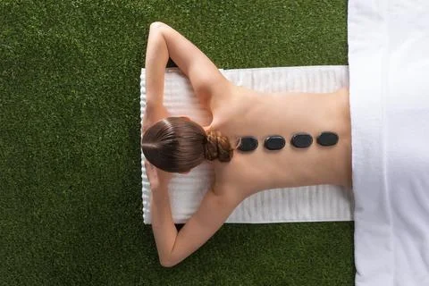 Woman lying on spa hot stone Stock Photos