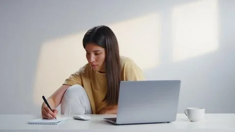 Woman make notes notebook, work computer laptop. Online study learning educ.. Stock Photos