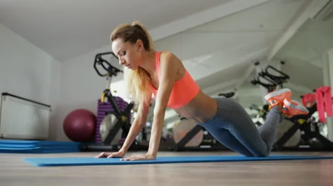 Woman make pilates exercise lying on floor in gym Stock Footage