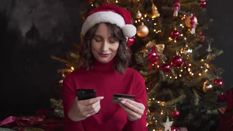 Woman make purchase online using smartphone and credit card buy New Year gifts Stock Footage 221529074
