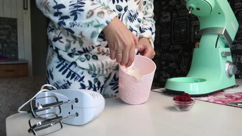 A woman makes cream for a cake using a mixer. Cooking cake Anna Pavlova. The  Stock Footage 210777298