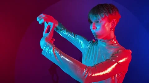 Woman makes cropping composition gesture in futuristic light indoors Stock Footage 239607729
