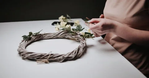 Woman makes Easter decoration in the form of an Easter wreath with eggs  Stock Footage 153275080