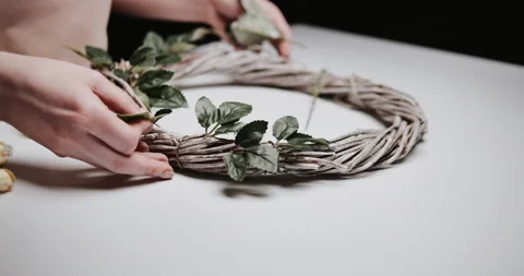 Woman makes Easter decoration in the form of an Easter wreath with eggs  Stock Footage 153275152