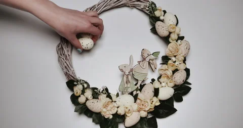 Woman makes Easter decoration in the form of an Easter wreath with eggs  Stock Footage 153275345