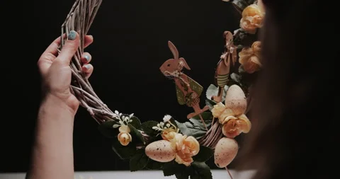 Woman makes Easter decoration in the form of an Easter wreath with eggs  Stock Footage 153275524