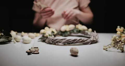Woman makes Easter decoration in the form of an Easter wreath with eggs  Stock Footage 153275631