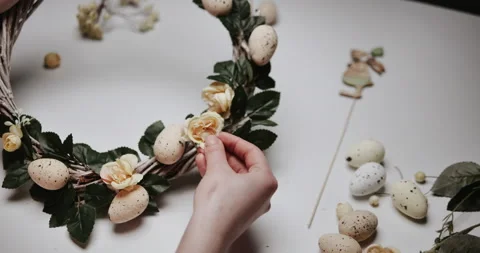 Woman makes Easter decoration in the form of an Easter wreath with eggs  Stock Footage 153275840
