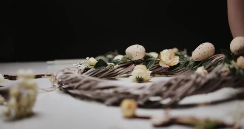 Woman makes Easter decoration in the form of an Easter wreath with eggs  Stock Footage 153275867