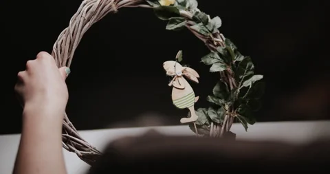 Woman makes Easter decoration in the form of an Easter wreath with eggs  Stock Footage 153276096