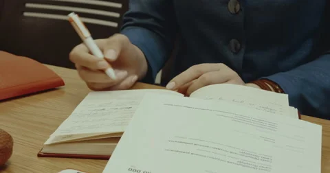 A woman makes an entry in the diary Stock Footage 64221182