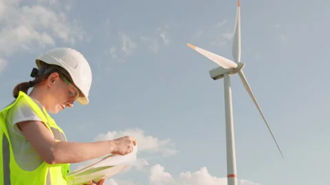 A woman makes an expertise in the field of ecological electricity for a wind Stock Footage 246535341