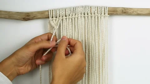 A woman makes home decor in Boho style. Woman making handmade decor weaves Stock Footage 147196509