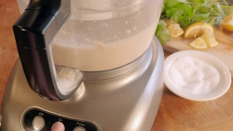 Woman Makes Hummus in Food Processor Stock Footage 78518234