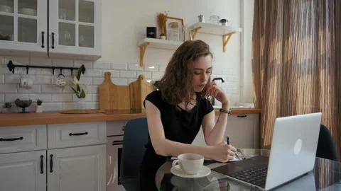 Woman makes notes in notepad watching lesson on laptop Video stock 201184536