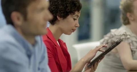 Woman makes notes on tablet computer during business meeting 4K Stock Footage 67385551