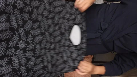 The woman makes an overview of the case for a suitcase. Vertical video Stock Footage 249742708
