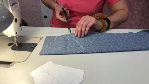 A woman makes a pattern for a mask Stock Footage 130581817