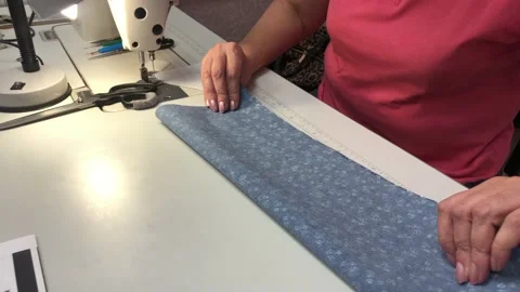 A woman makes a pattern for a mask Stock Footage 130581895