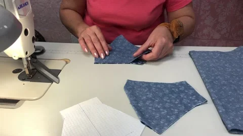 A woman makes a pattern for a mask Stock Footage 130582475