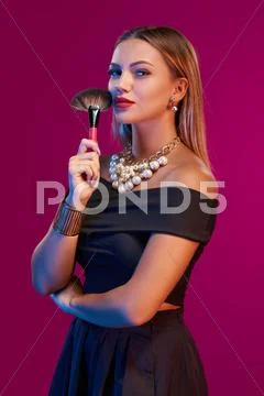 Woman makeup artist standing with brush Stock Photos