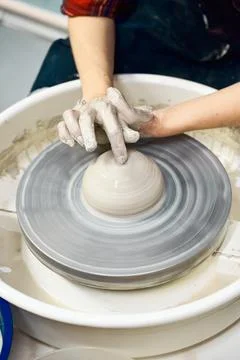 Woman making ceramic pottery, four hands close-up, focus on potters, palms with Stock Photos