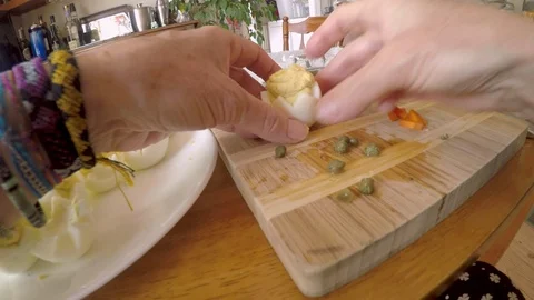 Woman making deviled eggs that look like chickens in a shell for Easter - POV Stock Footage 90812593