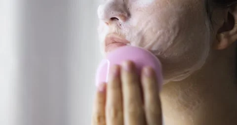 Woman is making face massage using face brush and foamy cleanser, closeup view. Stock Footage 133677976