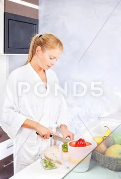 Woman making fruit salad in kitchen Stock Photos