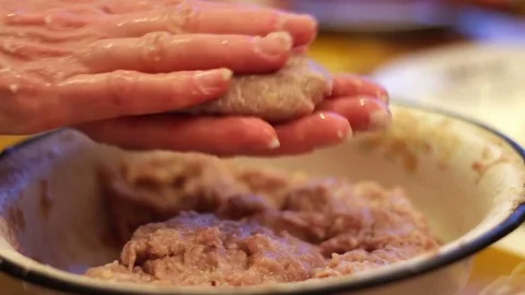 Woman making a hamburger cutlet with fresh mince in a home kitchen Stock Footage